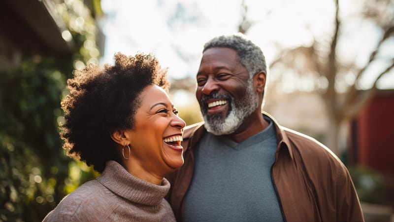 A couple sharing a laugh outdoors