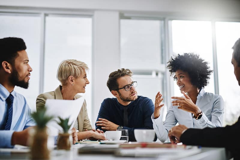 A team sharing ideas around a meeting table